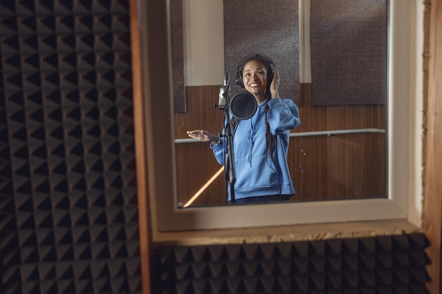 Professional vocal training instructor demonstrating singing techniques during lessons