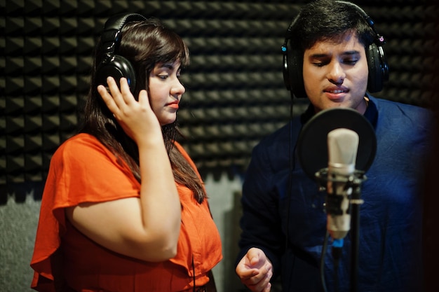 Professional singing lessons team instructor demonstrating vocal techniques for music students
